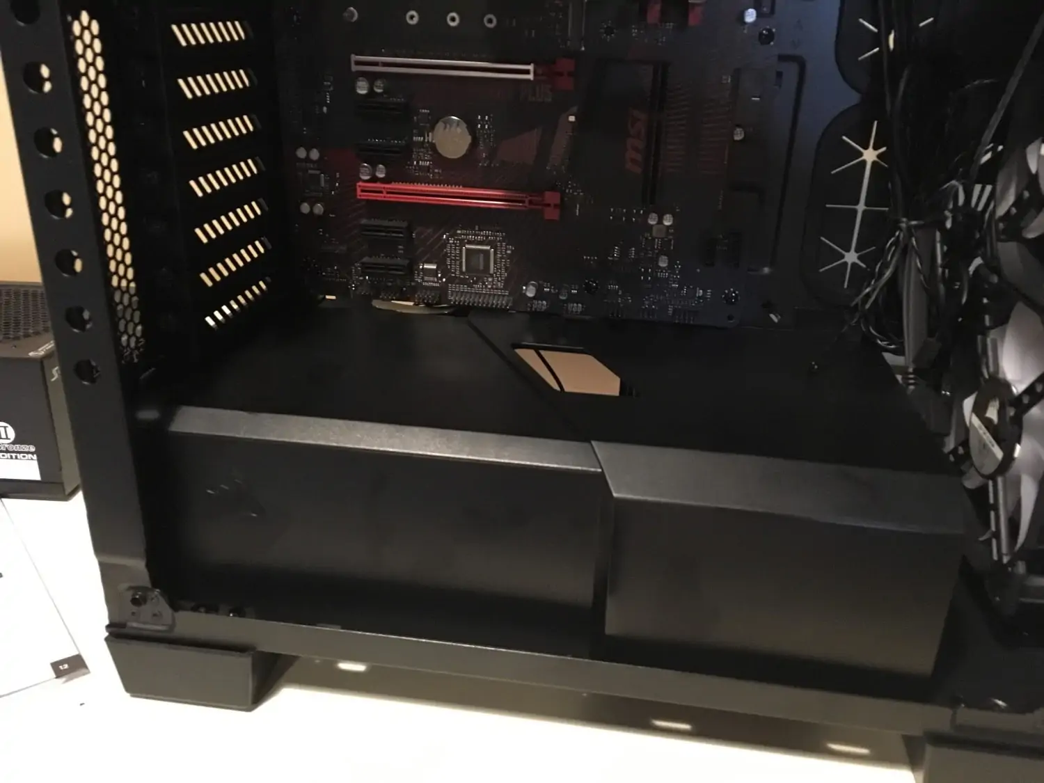 PSU shroud and routing grommets in a PC case